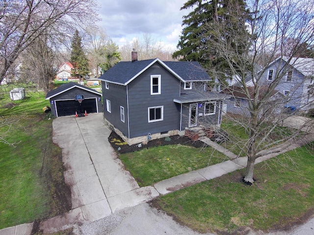 view of front facade with a front lawn, an outdoor structure, and a garage