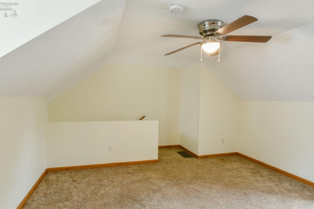 bonus room with ceiling fan, light colored carpet, and vaulted ceiling