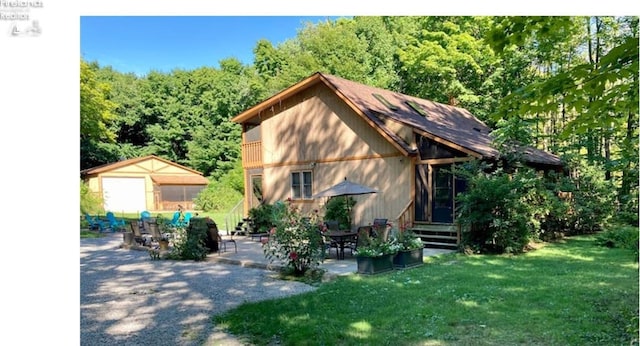 exterior space with a garage and a lawn