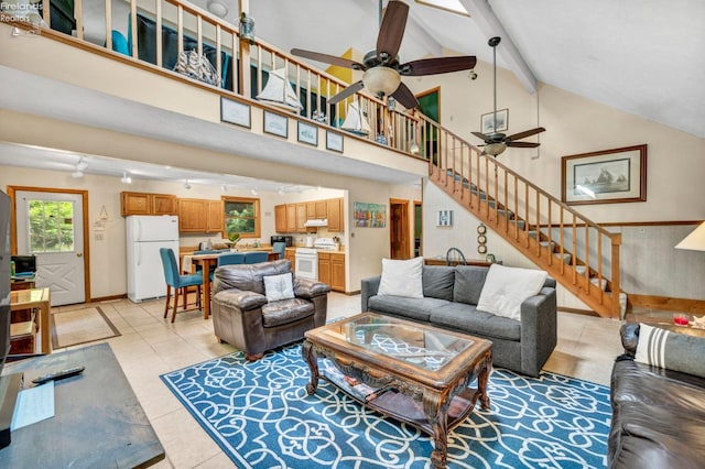 tiled living room featuring beamed ceiling, ceiling fan, and high vaulted ceiling