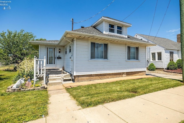 bungalow-style home with a front yard