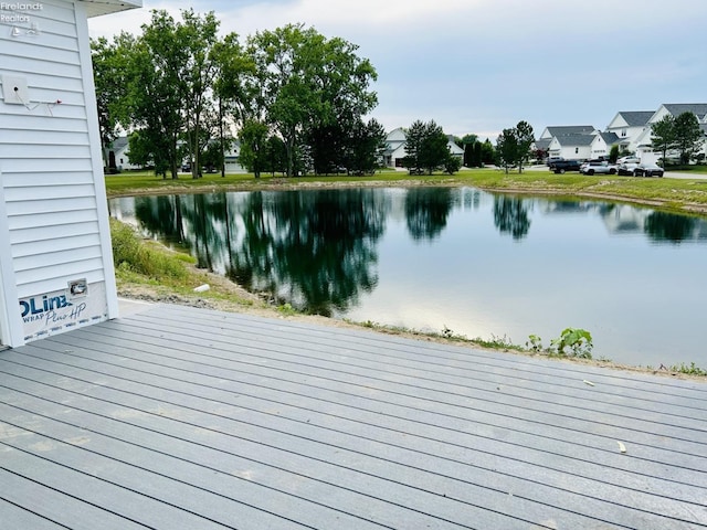 wooden deck featuring a water view