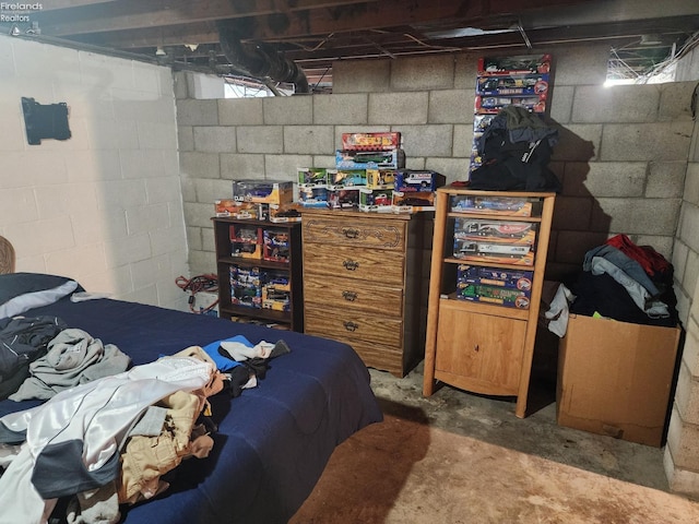 bedroom featuring concrete floors