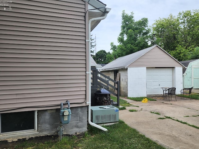 exterior space featuring a garage and an outbuilding