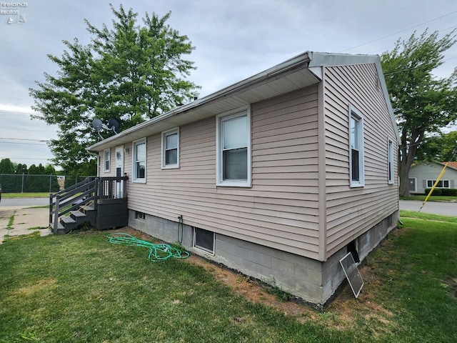 view of side of property with a lawn