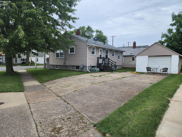 view of front of property with an outdoor structure, a garage, and a front lawn