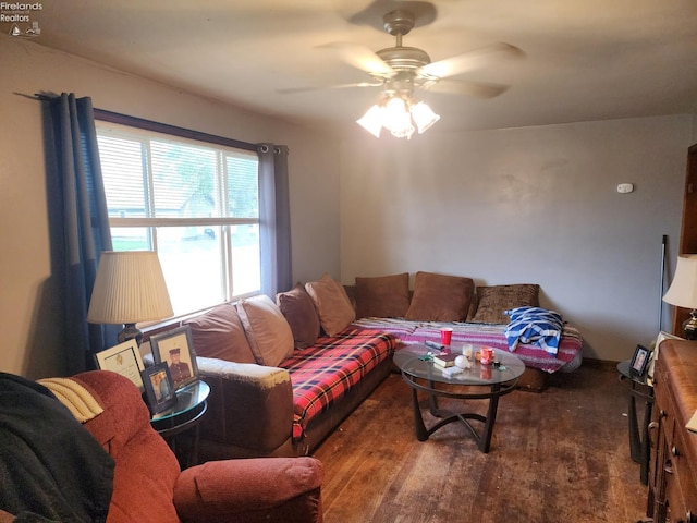 living room with dark hardwood / wood-style flooring and ceiling fan