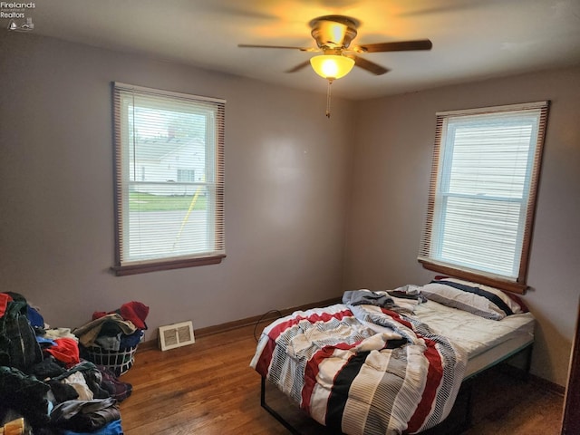 bedroom featuring dark wood-type flooring and ceiling fan