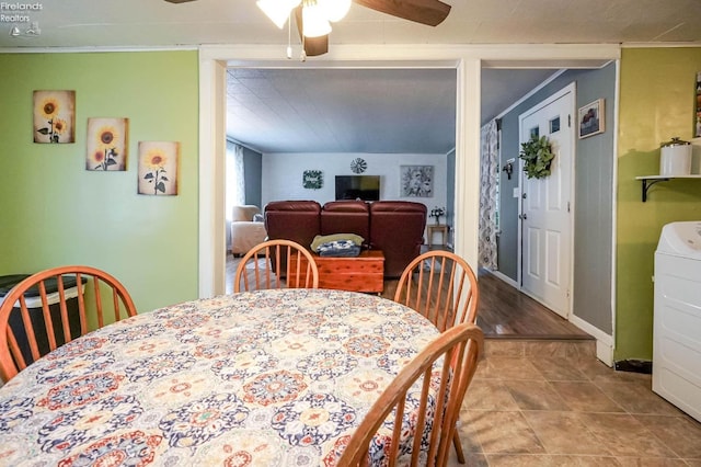 dining space featuring washer / clothes dryer, ceiling fan, and tile patterned floors