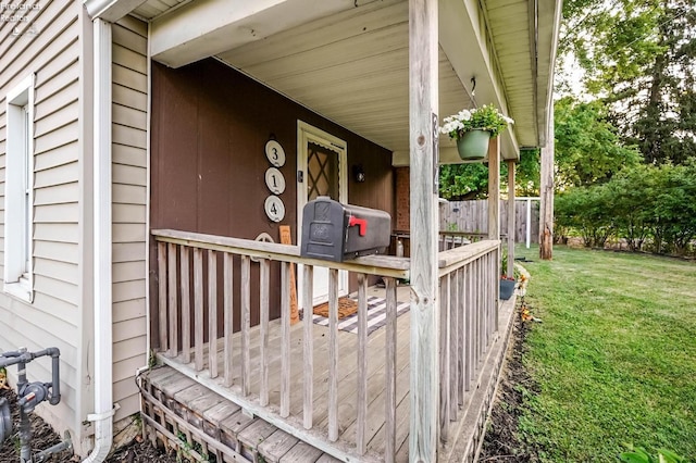 wooden deck featuring a lawn