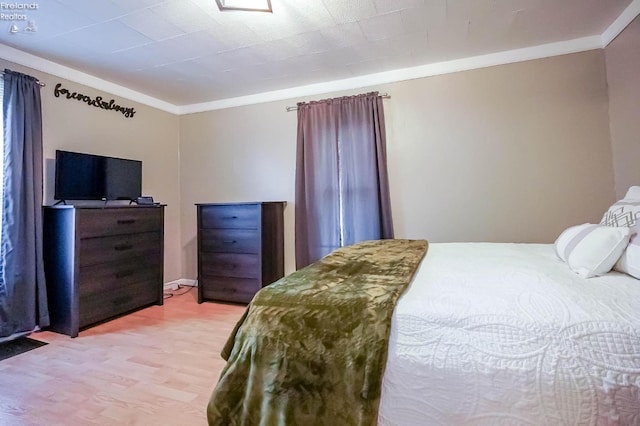 bedroom with crown molding and hardwood / wood-style flooring