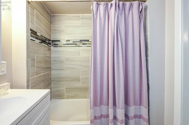 bathroom featuring shower / bath combo with shower curtain and vanity