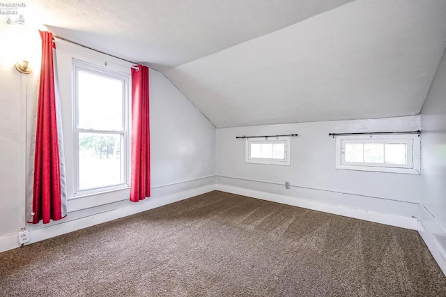 bonus room with carpet and vaulted ceiling