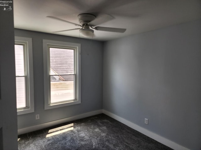 unfurnished room featuring ceiling fan and dark colored carpet