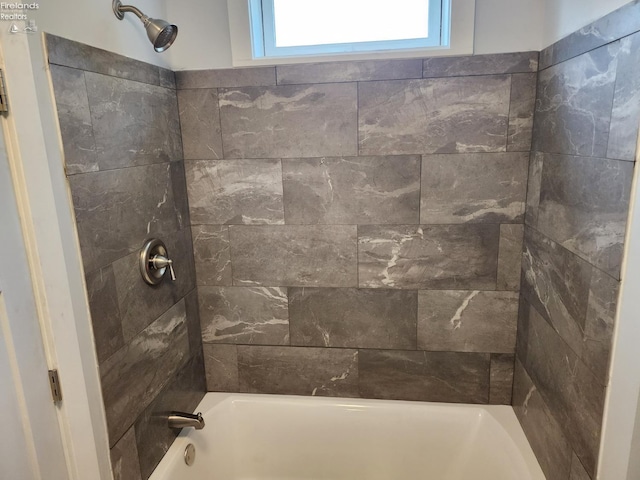 bathroom featuring tiled shower / bath