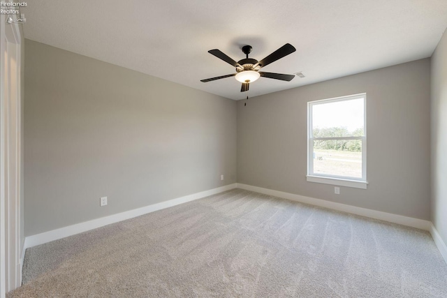 unfurnished room featuring ceiling fan and light colored carpet