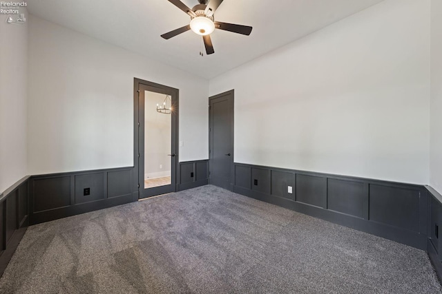 carpeted spare room with ceiling fan