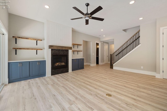 unfurnished living room featuring light hardwood / wood-style floors and ceiling fan