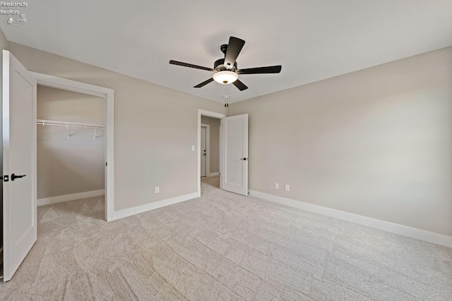 unfurnished bedroom with a closet, ceiling fan, and light carpet