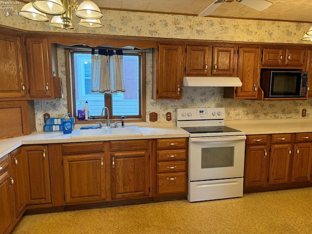 1225 White Ave, Fremont, OH 43420 - kitchen featuring a sink, white electric range, under cabinet range hood, and wallpapered walls