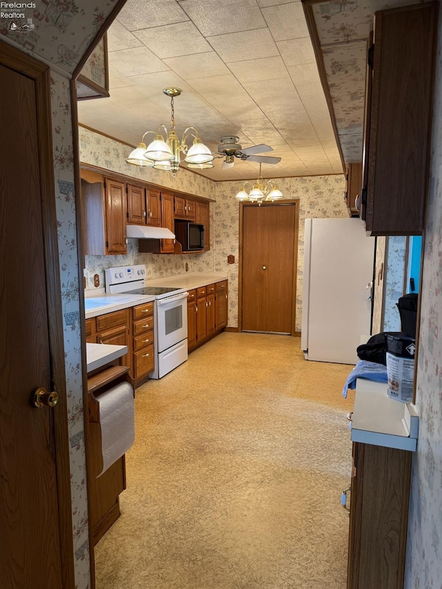 kitchen featuring white appliances, pendant lighting, backsplash, ceiling fan with notable chandelier, and light carpet