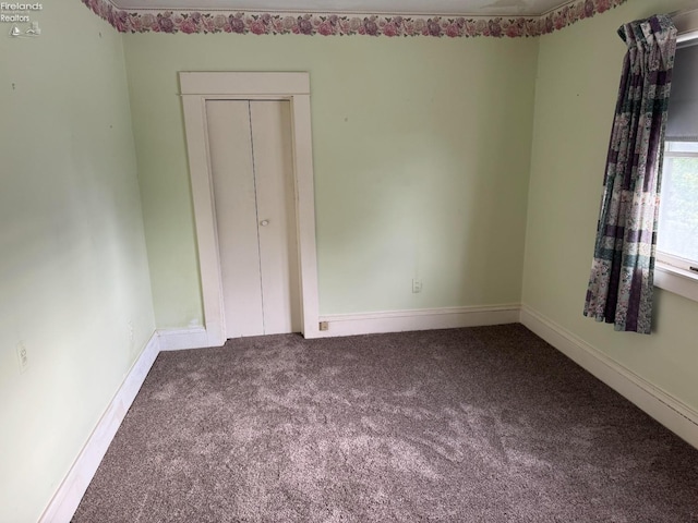 unfurnished bedroom featuring a closet and carpet flooring