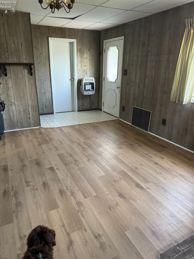 1225 White Ave, Fremont, OH 43420 - interior space with a notable chandelier, wood walls, visible vents, light wood-style floors, and heating unit