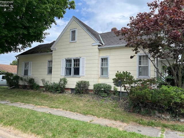 view of side of home with a lawn