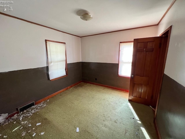 carpeted spare room with crown molding