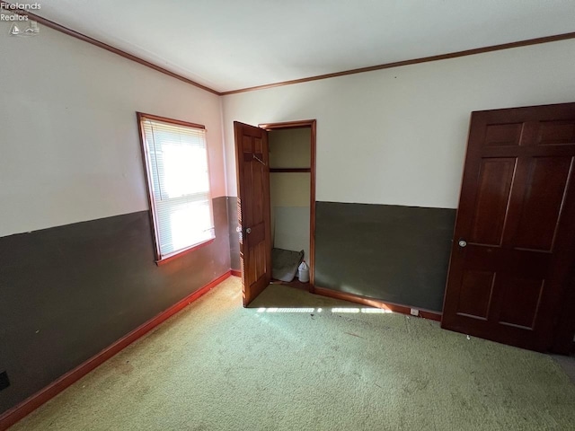 unfurnished bedroom featuring light colored carpet and ornamental molding