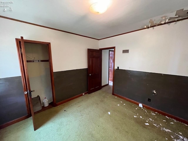 unfurnished bedroom featuring carpet floors and ornamental molding