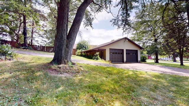 exterior space featuring an outbuilding, a garage, and a yard