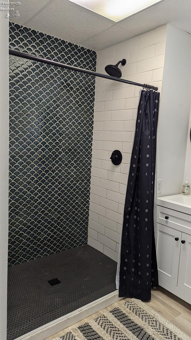 bathroom featuring curtained shower, vanity, and hardwood / wood-style floors