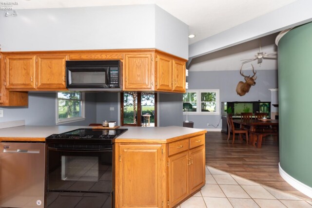 kitchen featuring plenty of natural light, dishwasher, light hardwood / wood-style flooring, and electric range oven