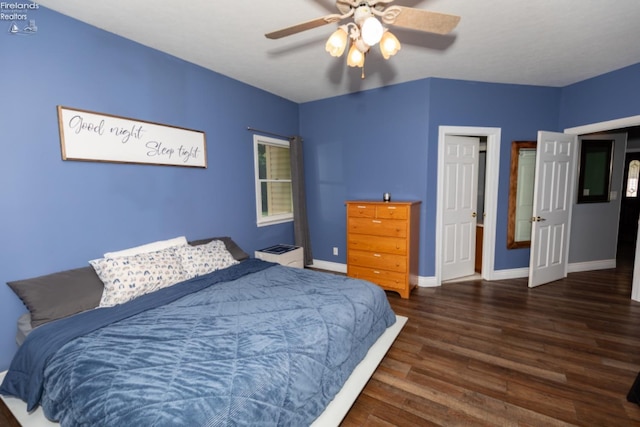 bedroom with dark wood-type flooring and ceiling fan