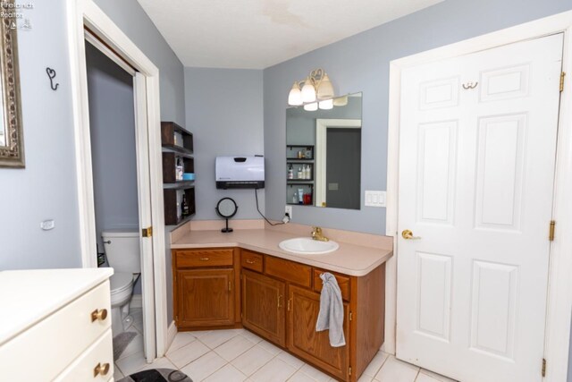 bathroom featuring tile patterned floors, toilet, and vanity