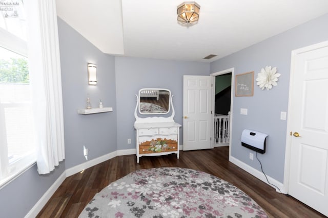 sitting room with heating unit and dark hardwood / wood-style flooring