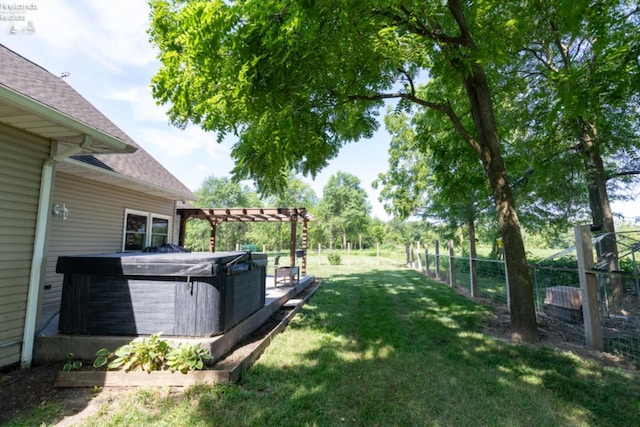 view of yard featuring a hot tub and a pergola