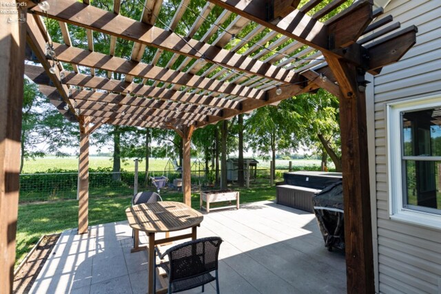 view of patio / terrace with a pergola and a hot tub