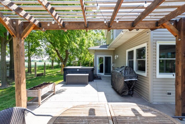 view of patio / terrace featuring a pergola and a hot tub