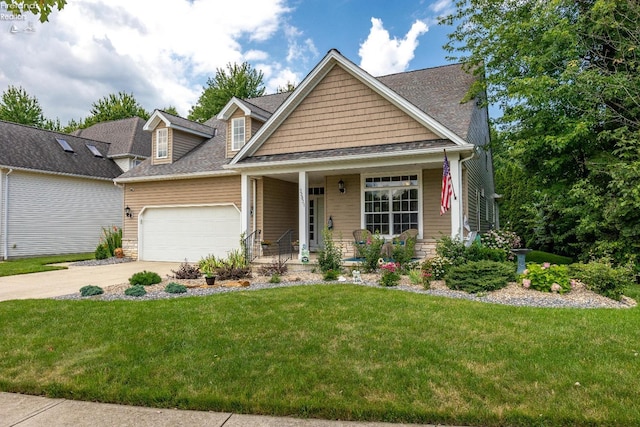 craftsman-style house featuring a garage, a front lawn, and covered porch