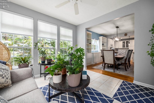 living room with ceiling fan and light tile patterned floors