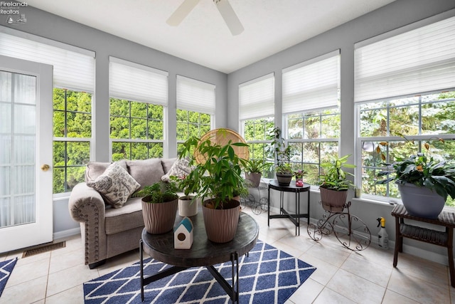 sunroom / solarium with ceiling fan and a healthy amount of sunlight