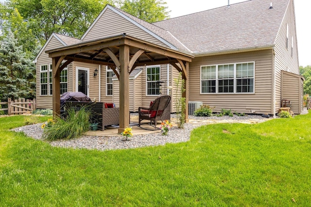 rear view of house with central AC unit, a patio area, and a yard