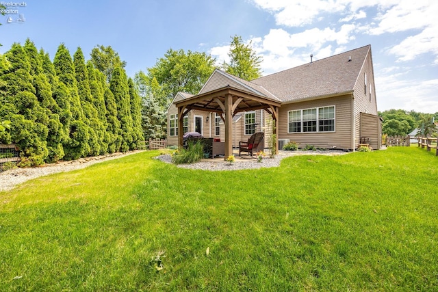 view of front of home featuring a front lawn and a gazebo