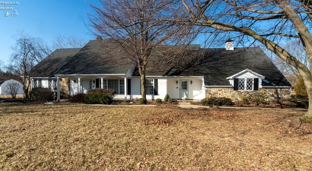 cape cod house with a front lawn