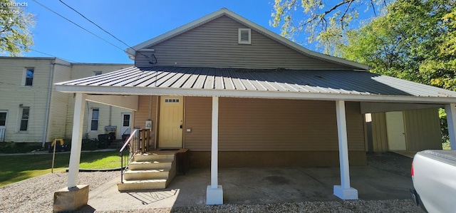 back of house featuring covered porch