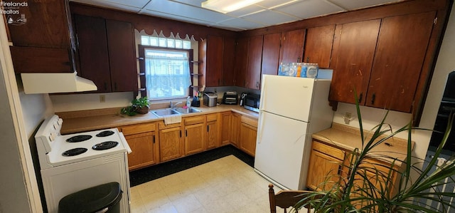 kitchen featuring sink, white appliances, and range hood