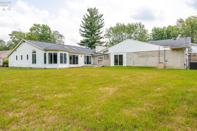 rear view of house with a lawn