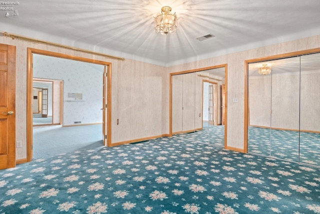 basement featuring carpet floors and a chandelier